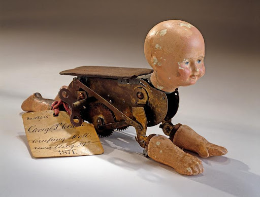 The Natural Creeping Baby Doll designed by George Pemberton Clarke (1871). Mechanical devices like this were  built to imitate human life, and shaped ideas about human behavior, agency, and our relationship to technology. Source: Smithsonian.